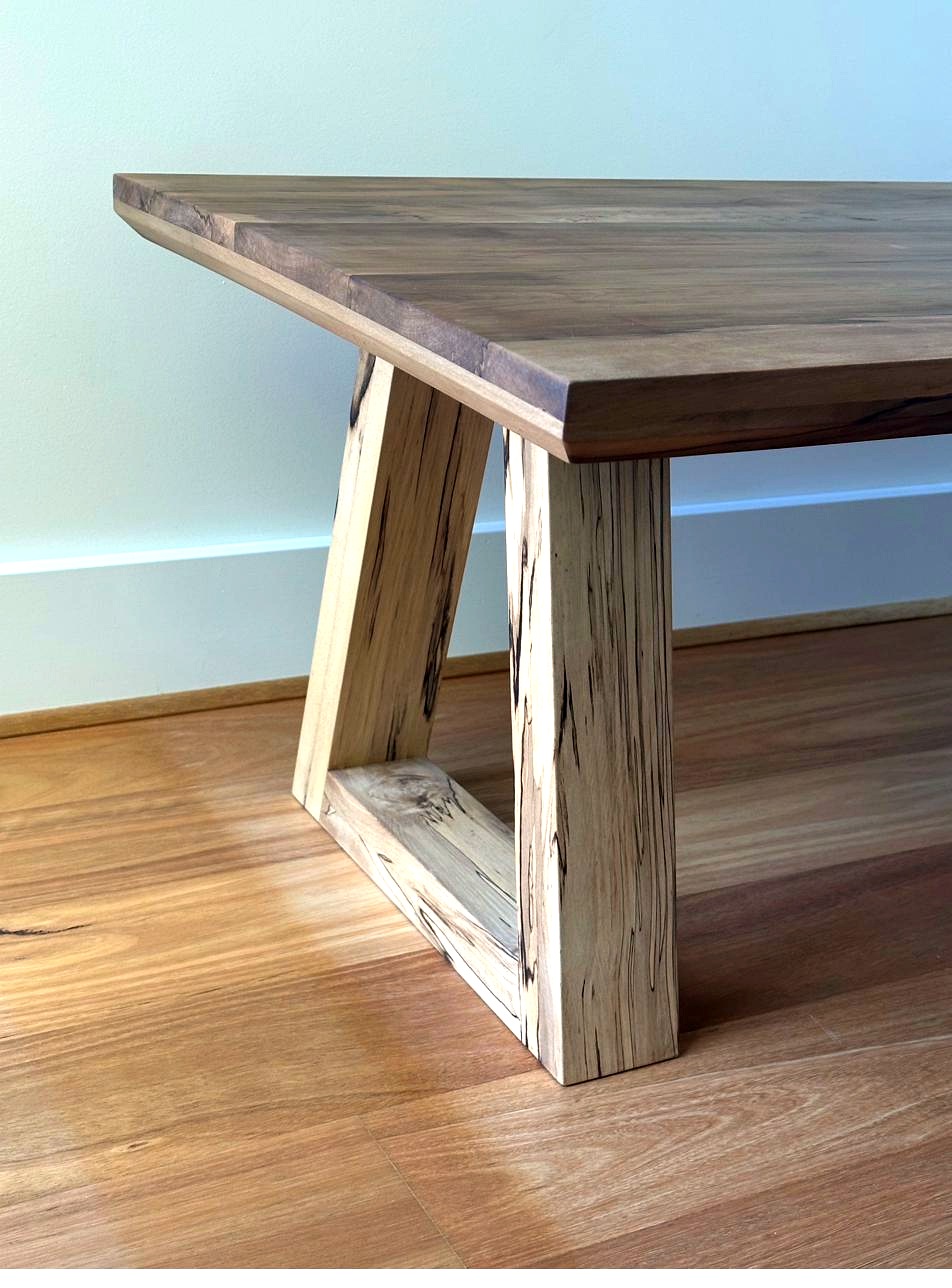 Close-up of Tasmanian sassafras coffee table leg and top edge