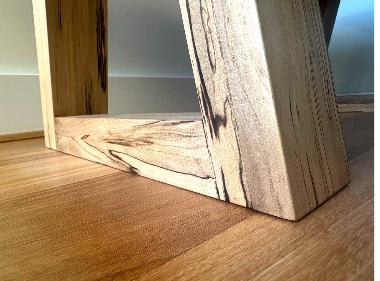 Ground-level view of Tasmanian sassafras coffee table foot and base rail